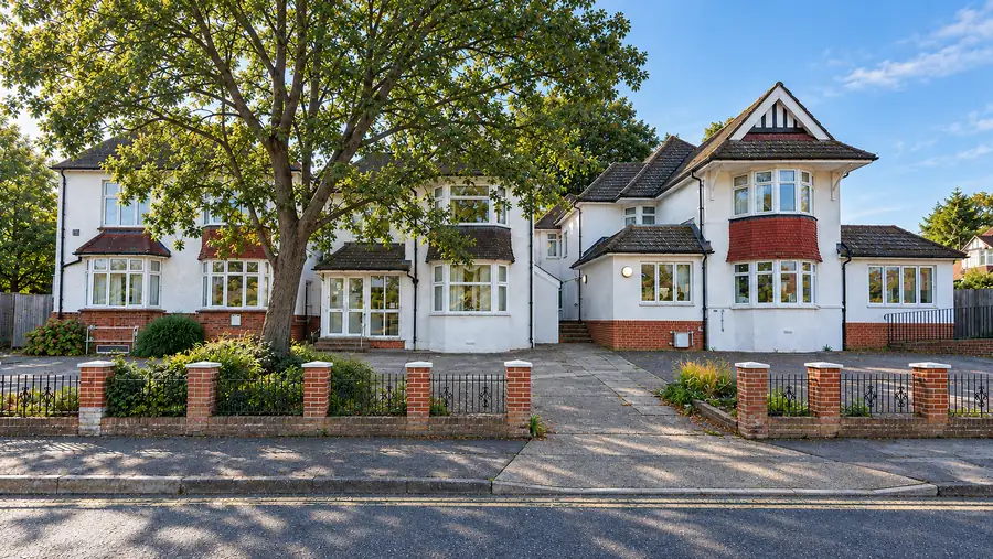 Oak House from Maidstone Road: a white-rendered house with a red-tiled bay, a large tree to one side and brick-pier railings along the pavement